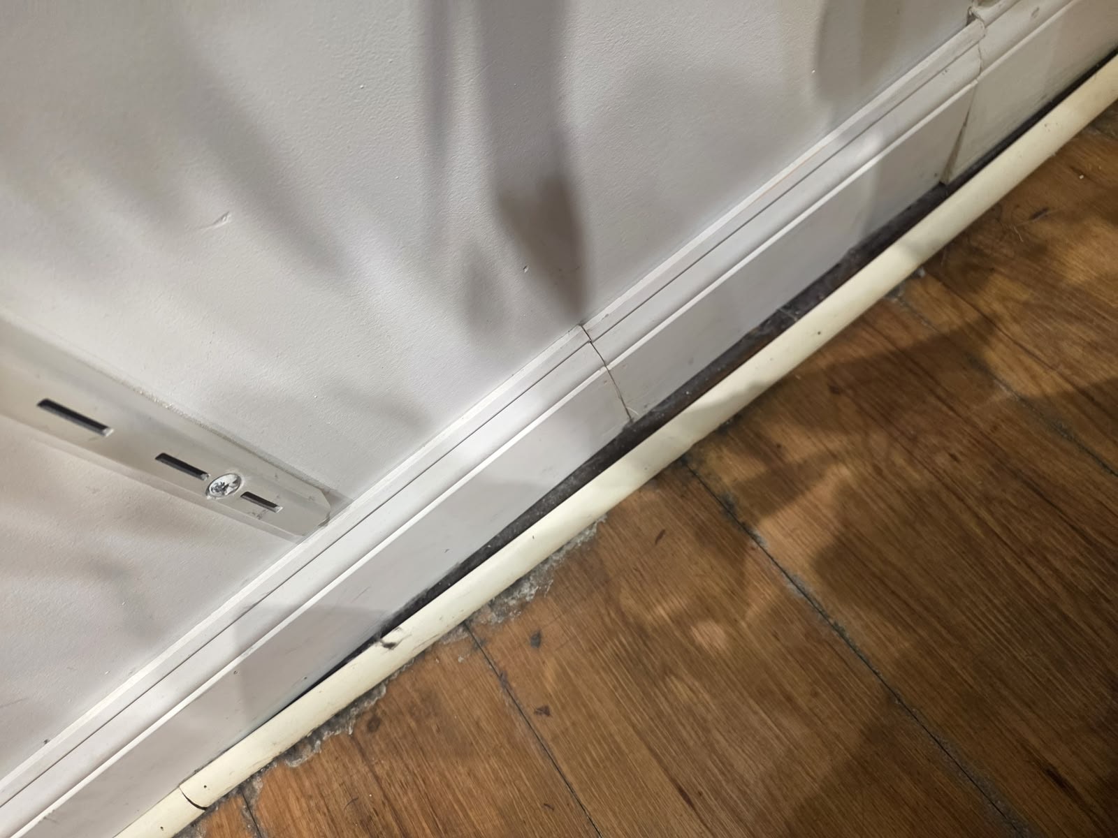 Baseboard Reattachment & Repair — Before